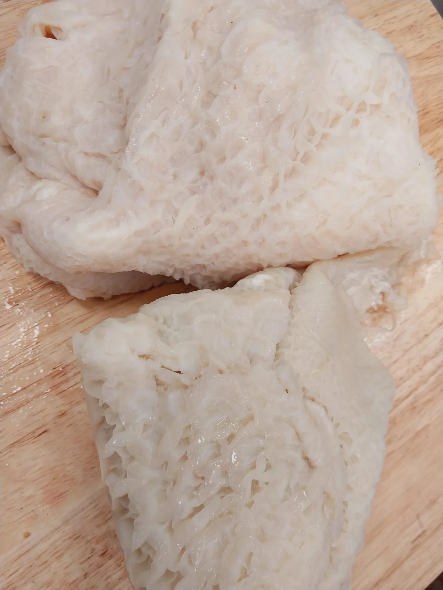 Fresh cleaned halal beef tripe on a wooden cutting board