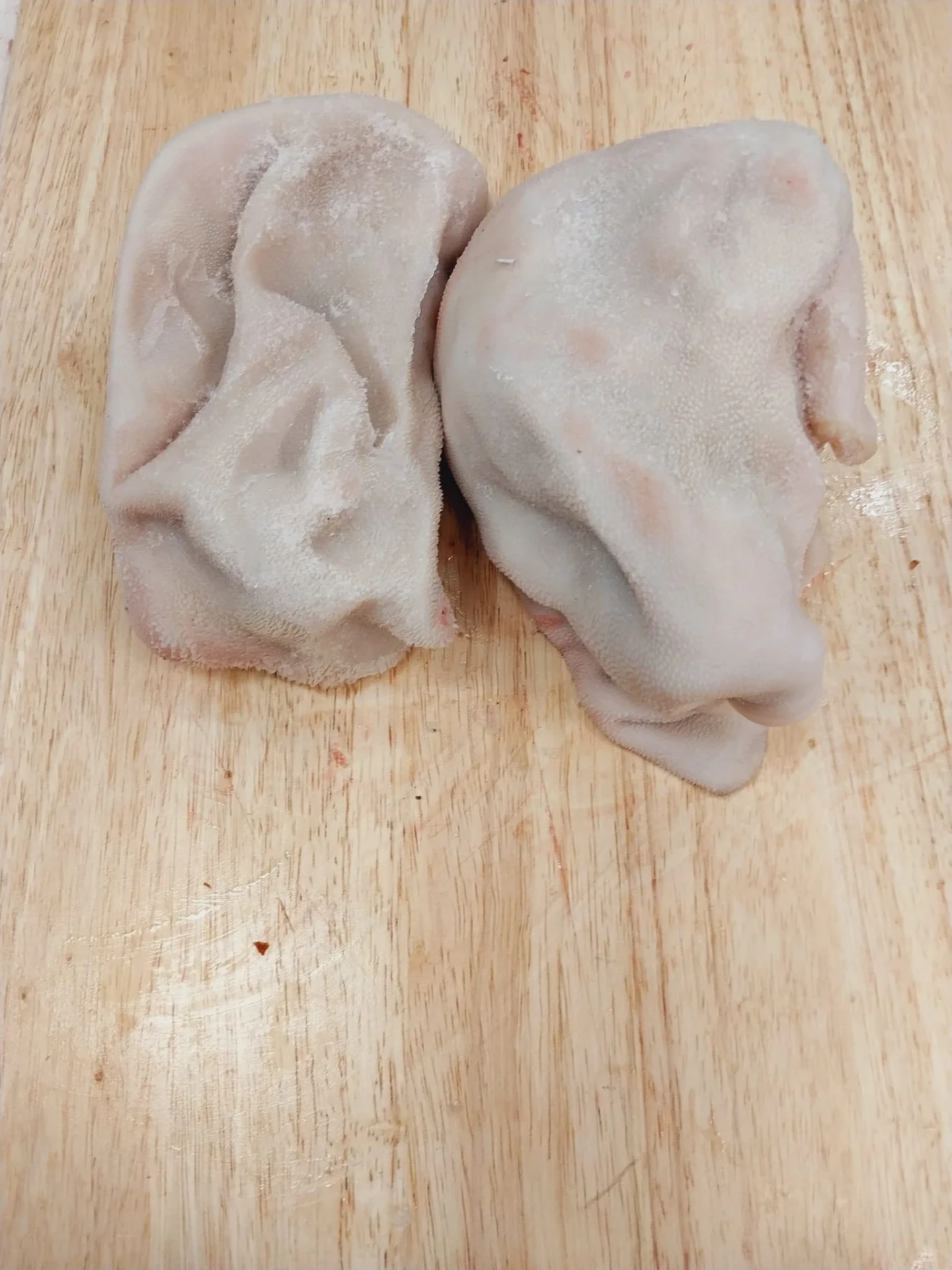 Fresh cleaned halal goat tripe on a wooden cutting board