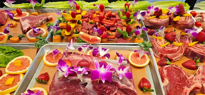 Trays of premium halal bone-in chops and thick cut steaks with fresh garnish